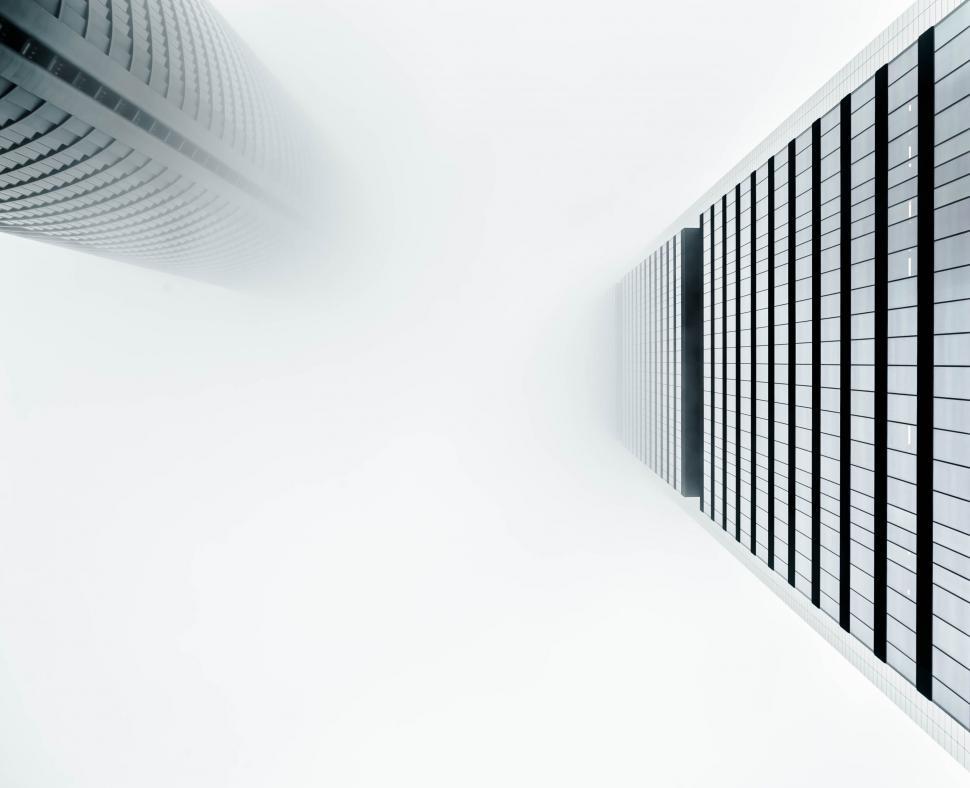 Free Image of Tall skyscrapers piercing through fog in urban landscape 