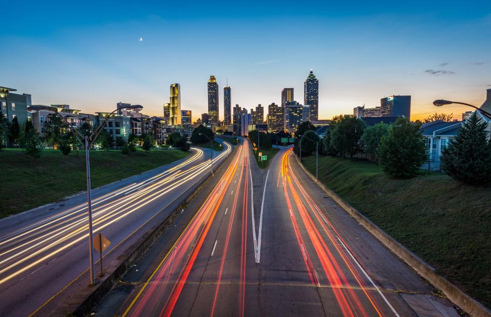 Free Image of Nighttime cityscape with vibrant light trails captured. 