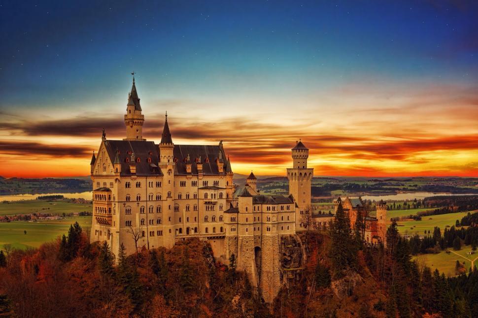 Free Image of Majestic castle at sunset overlooking scenic landscape. 
