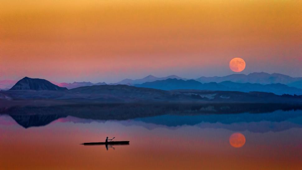 Free Image of Boat on still lake under a colorful sunset moonrise sky. 
