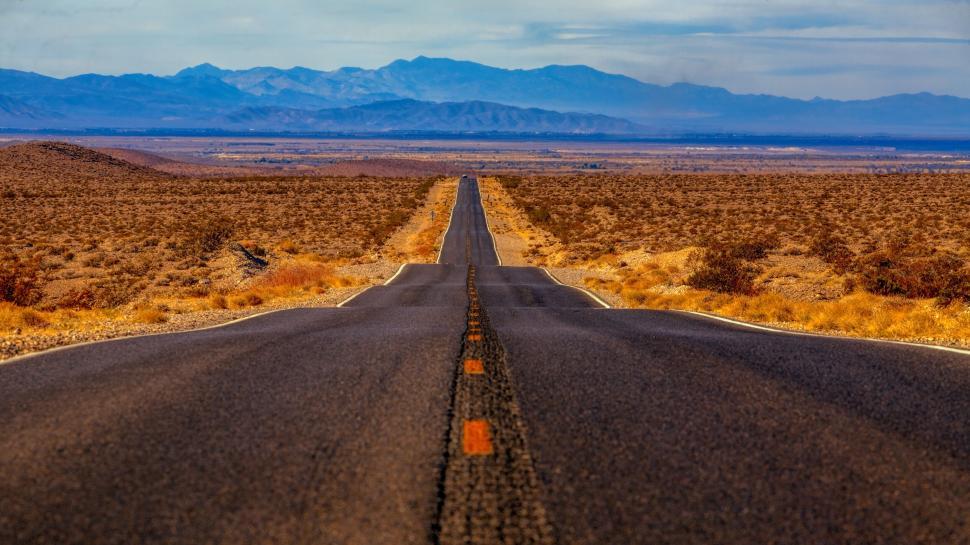 Free Image of Long straight road through desert to distant mountains 