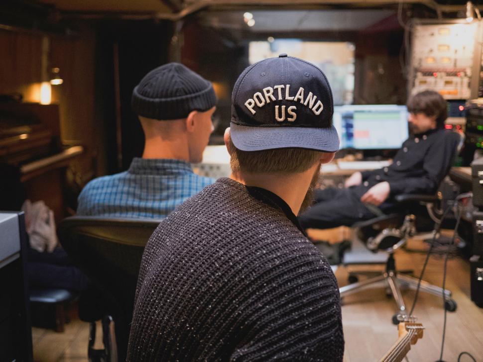 Free Image of Musicians collaborating in a recording studio environment 