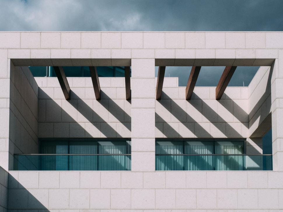 Free Image of Modern architecture with large windows and wooden beams. 