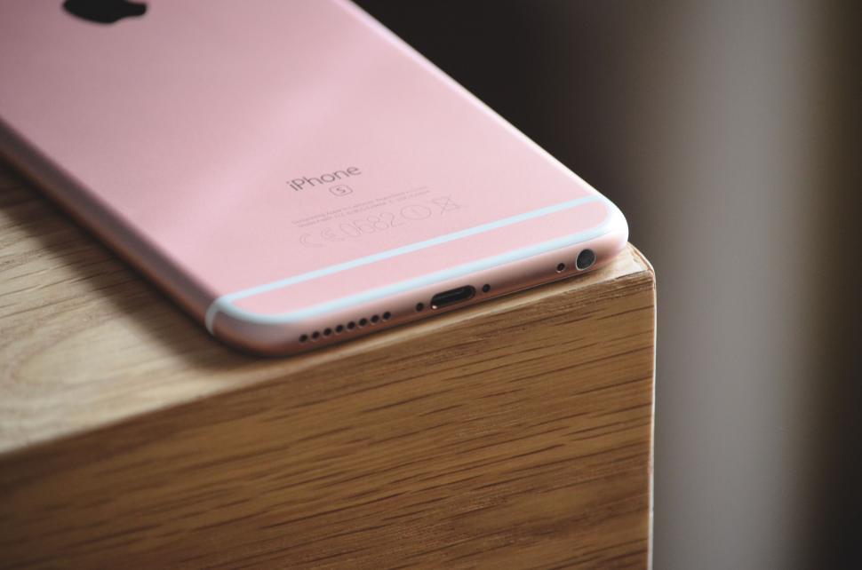 Free Image of Rose gold iPhone 6s placed on wooden table 