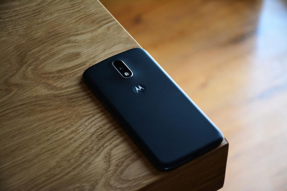 Free Image of Black Motorola smartphone placed on wooden table 