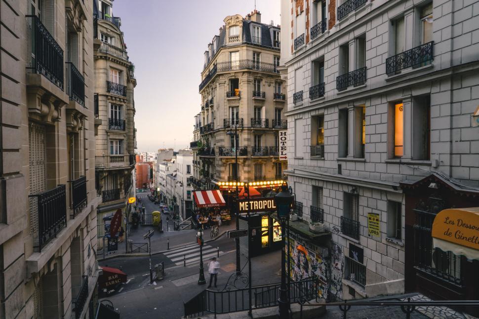Free Image of Parisian street with buildings and a Metro sign at dusk 