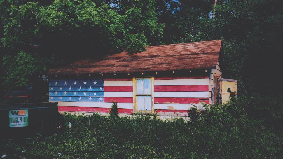 Free Image of Small house decorated with American flag paint job theme 