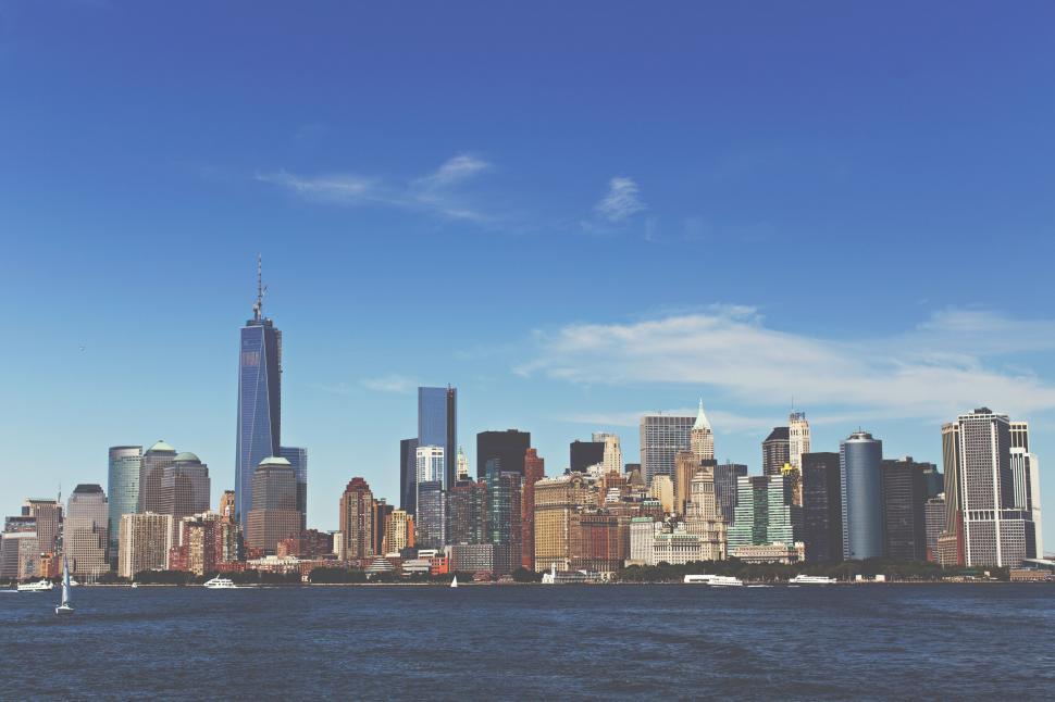 Free Image of Modern city skyline with tall buildings against blue sky. 