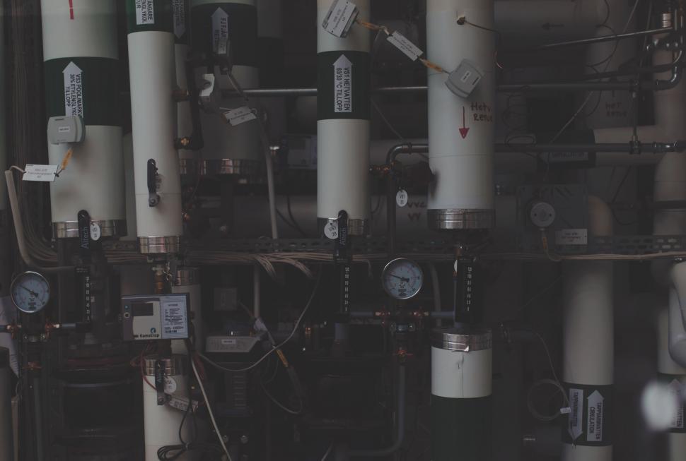 Free Image of Complex industrial machinery with pipes and gauges depicted. 