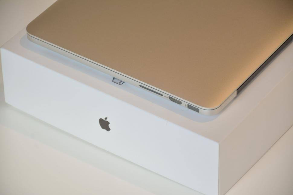 Free Image of Closed Apple laptop resting on white packaging box 