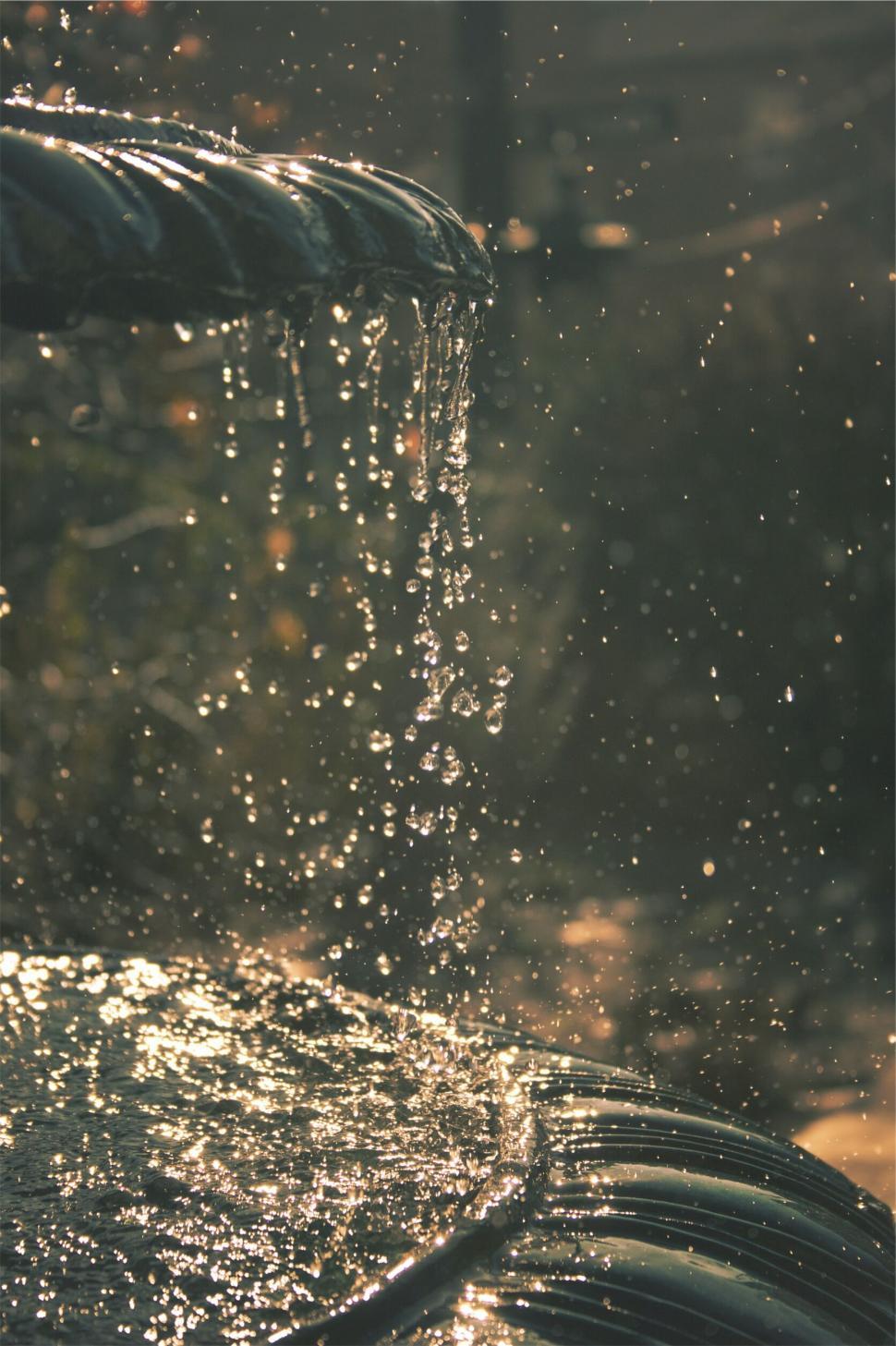 Free Image of Water splashing down fountain in tiered droplets at dusk. 
