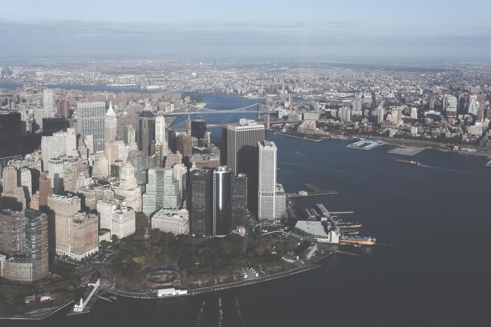 Free Image of Aerial view of urban cityscape by a large body of water 