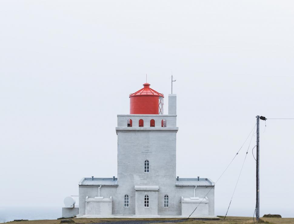 Free Image of Stylish modern lighthouse with a red top and white base 