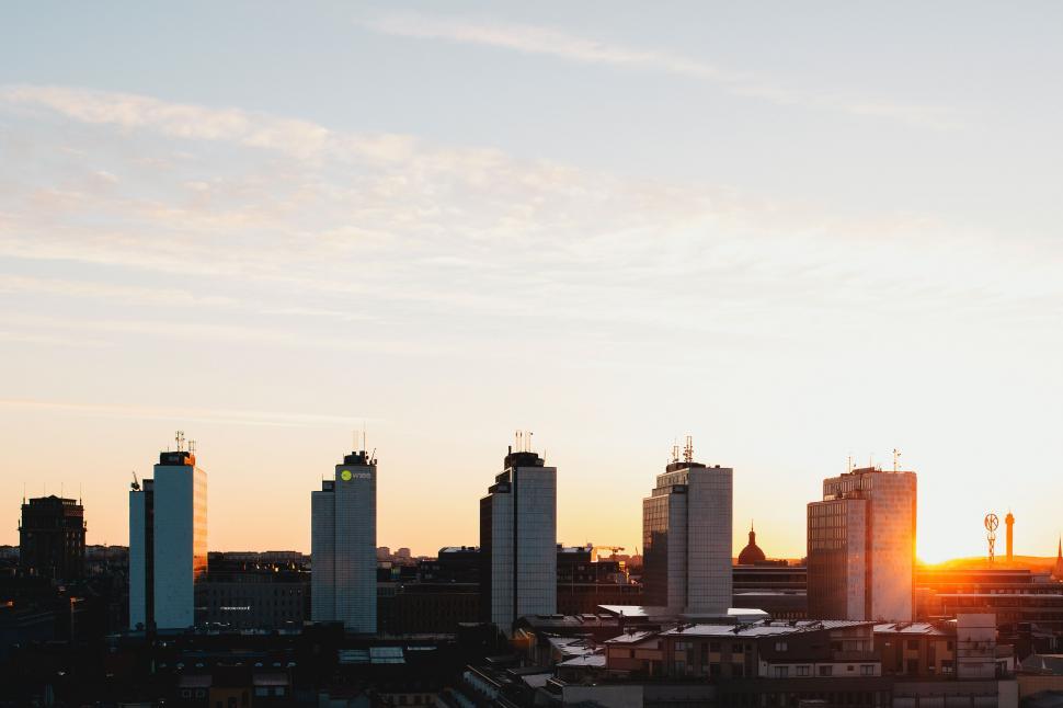 Free Image of City skyline with tall buildings at sunset under clear sky 
