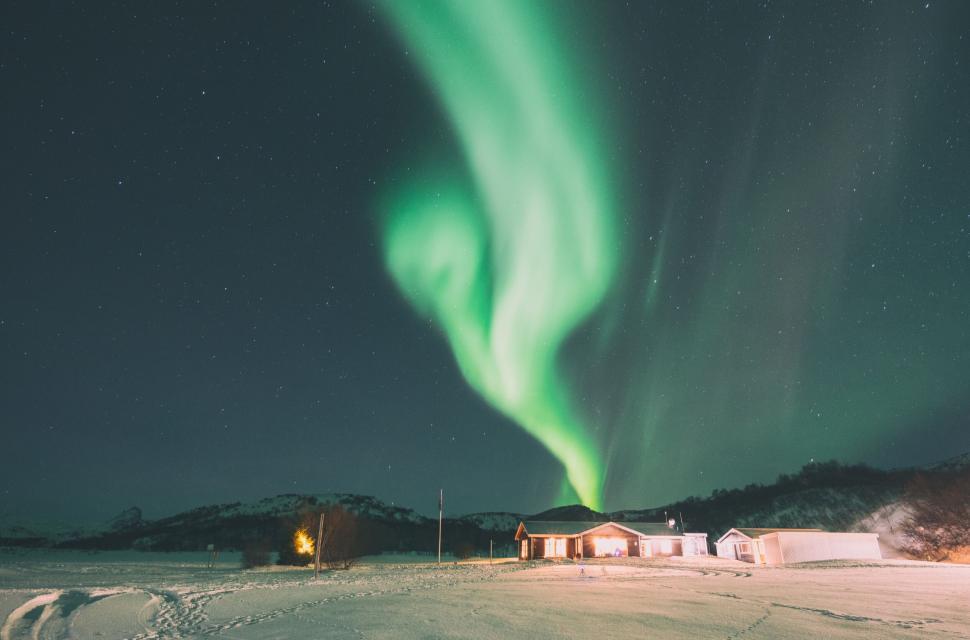 Free Image of Night sky lit up by the mesmerizing Northern Lights. 