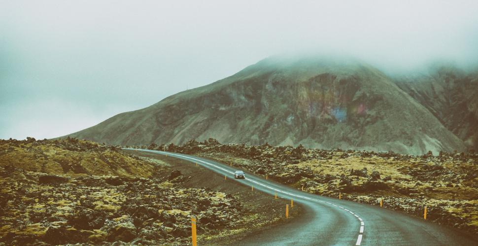 Free Image of Winding road cutting through rocky volcanic terrain 
