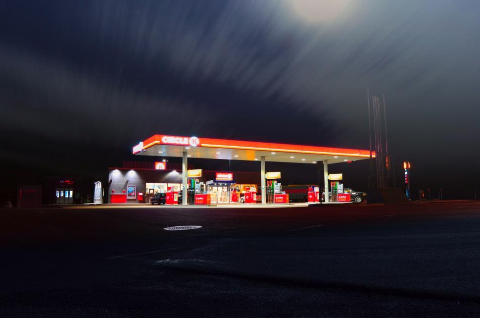 Free Image of A well-lit gas station at night with clear sky above. 