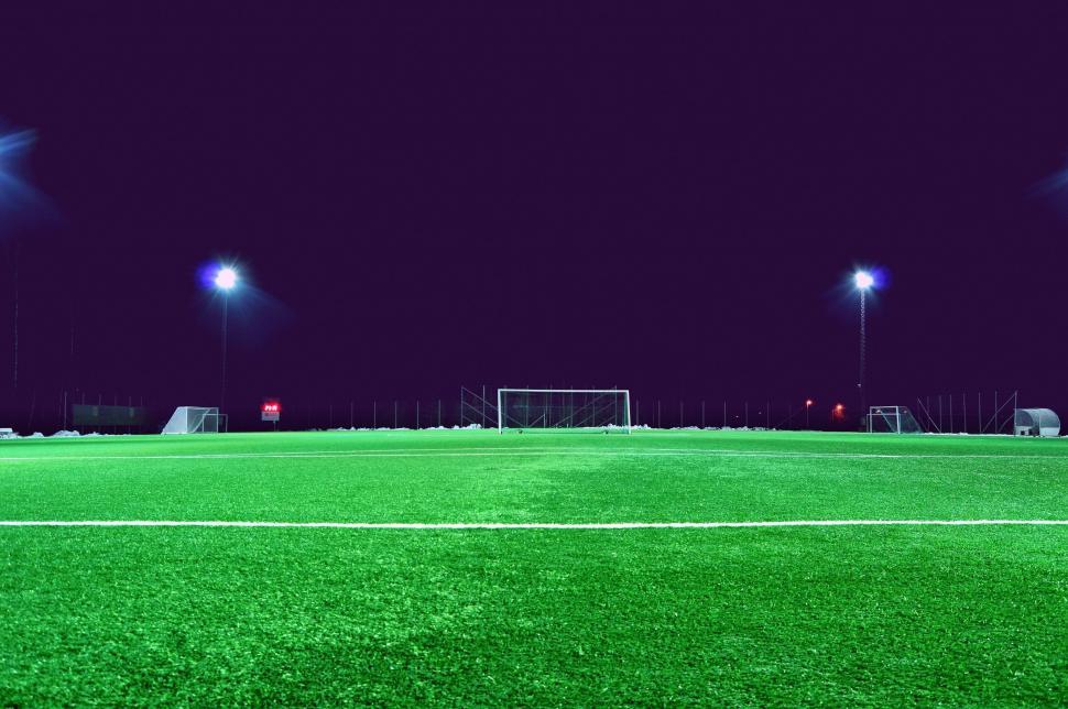 Free Image of Well-lit empty football field under the night sky. 