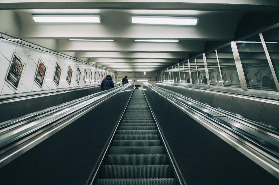 Free Image of Subway escalator going down with people in the back 
