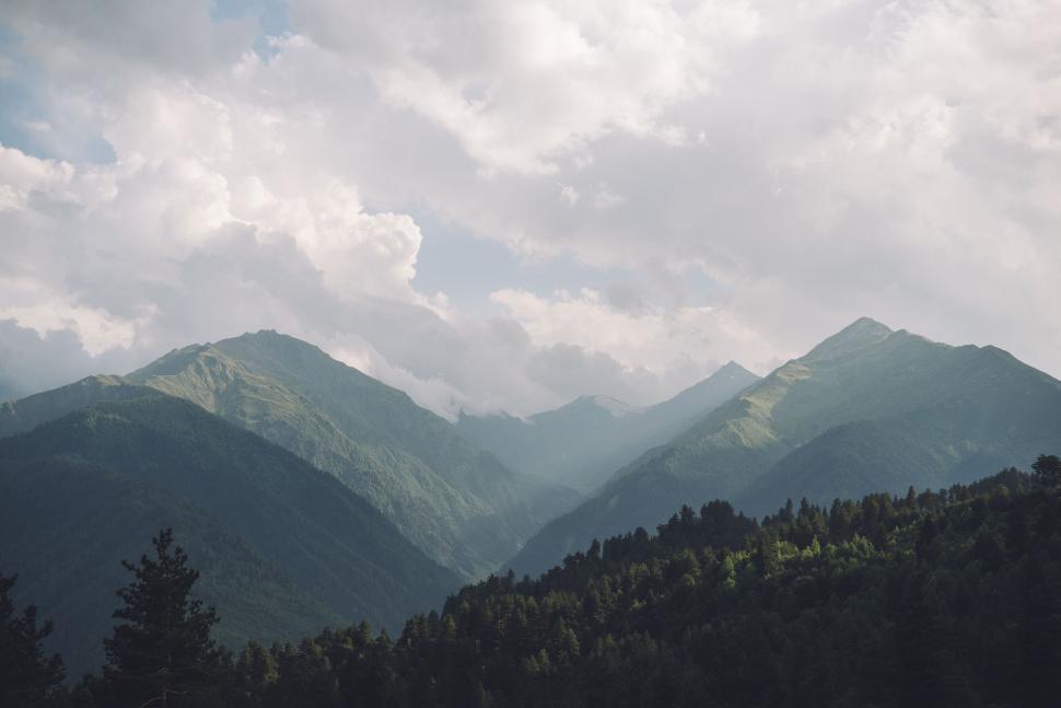 Free Image of Scenic mountain landscape with cloudy sky backdrop 