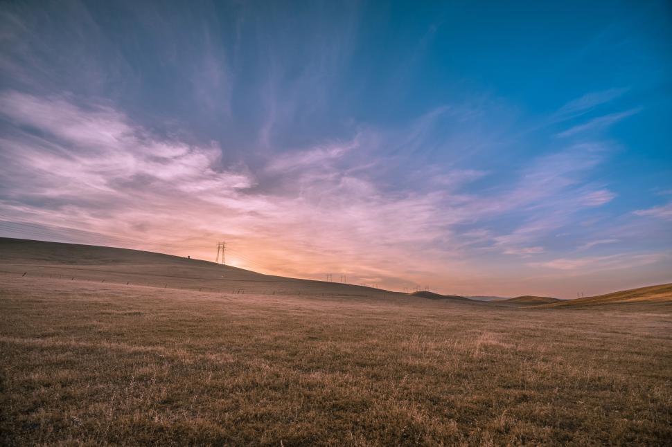 Free Image of Expansive and serene landscape with a stunning sunset sky. 