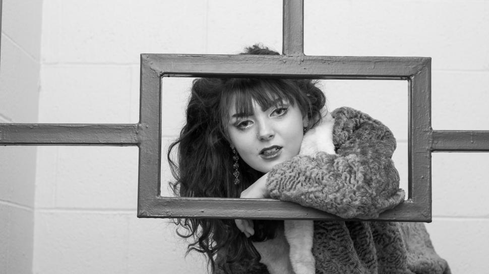 Free Image of Black and white photo of woman in knitted sweater 