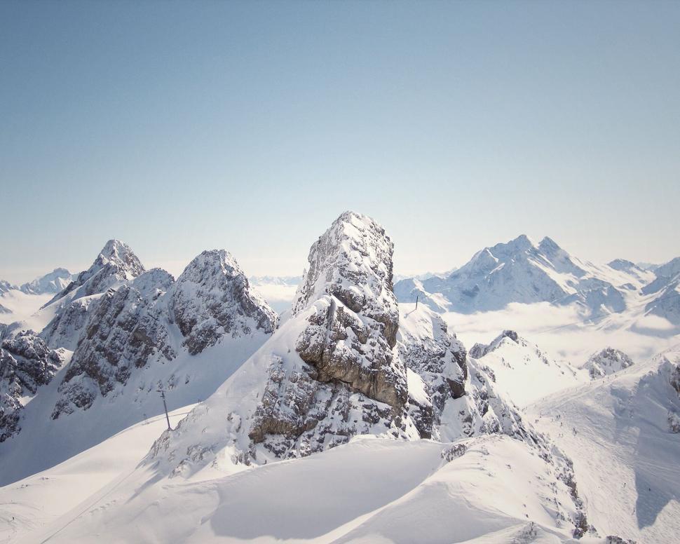 Free Image of Snow-capped mountains with clear blue daytime sky 