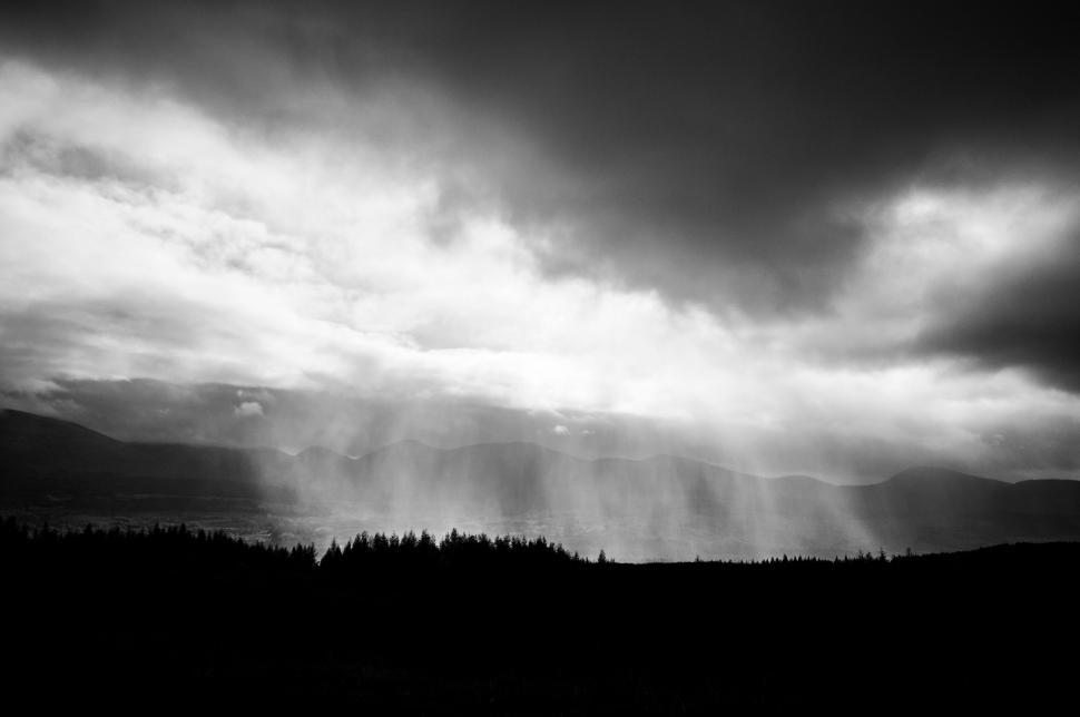 Free Image of Black and white landscape with dramatic clouds and light 