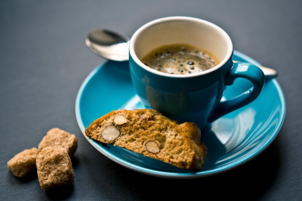 Free Image of Espresso in blue cup with biscotti on the saucer. 