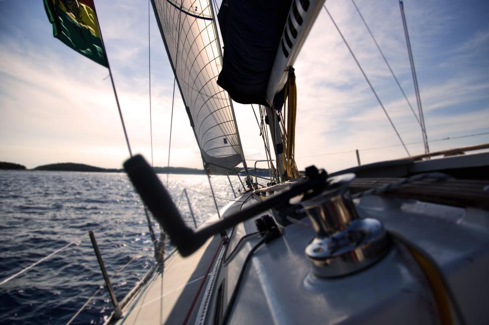 Free Image of Sailboat gliding on serene waters under a clear sky 