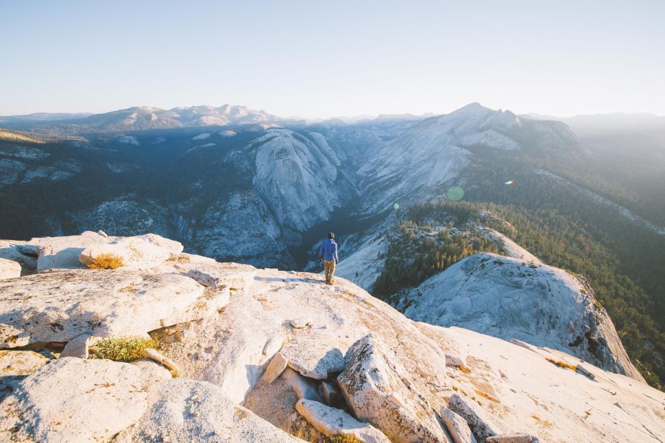 Free Image of Adventurer stands triumphantly atop a mountain peak 
