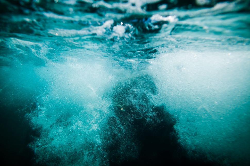 Free Image of Bubbles swirling under the surface of turbulent water. 