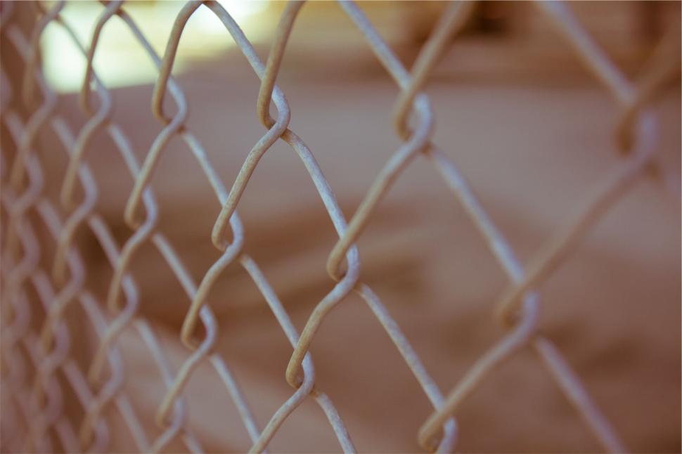 Free Image of Close-up of chain-link fence with blurred background. 
