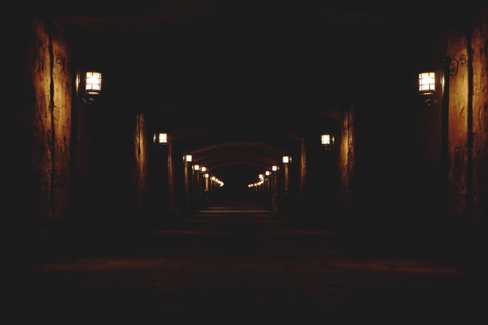 Free Image of Mysterious dimly-lit hallway with vintage lamp lights 