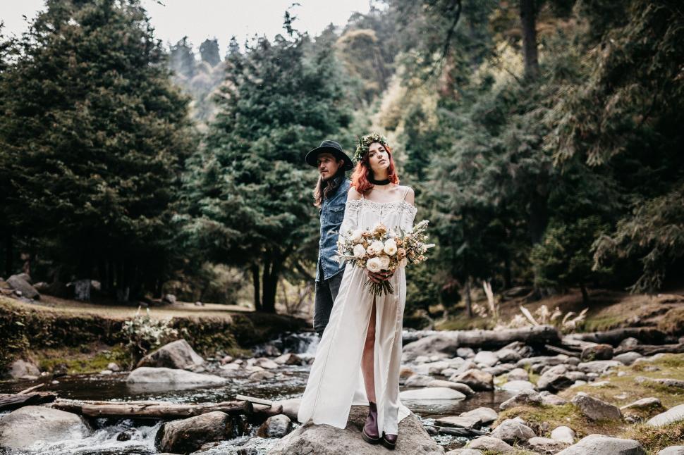 Free Image of Couple posing for a photo in a serene forest setting 