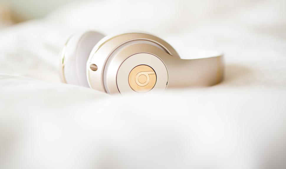 Free Image of Sleek white and gold headphones on a soft white surface 