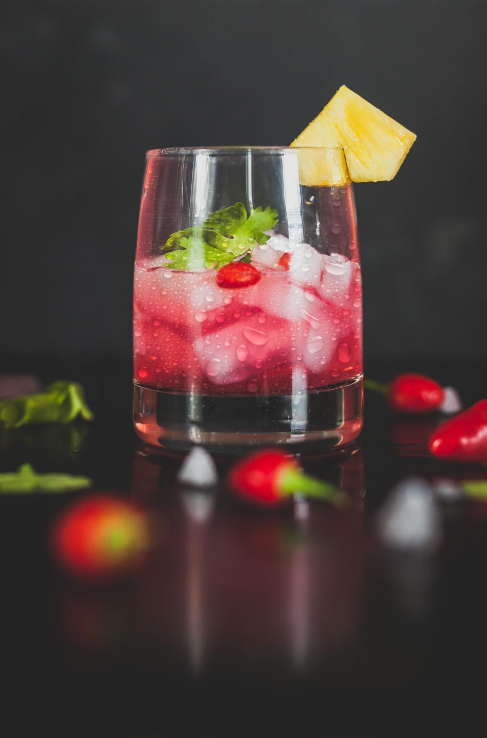 Free Image of Refreshing red and yellow cocktail with garnish on top 