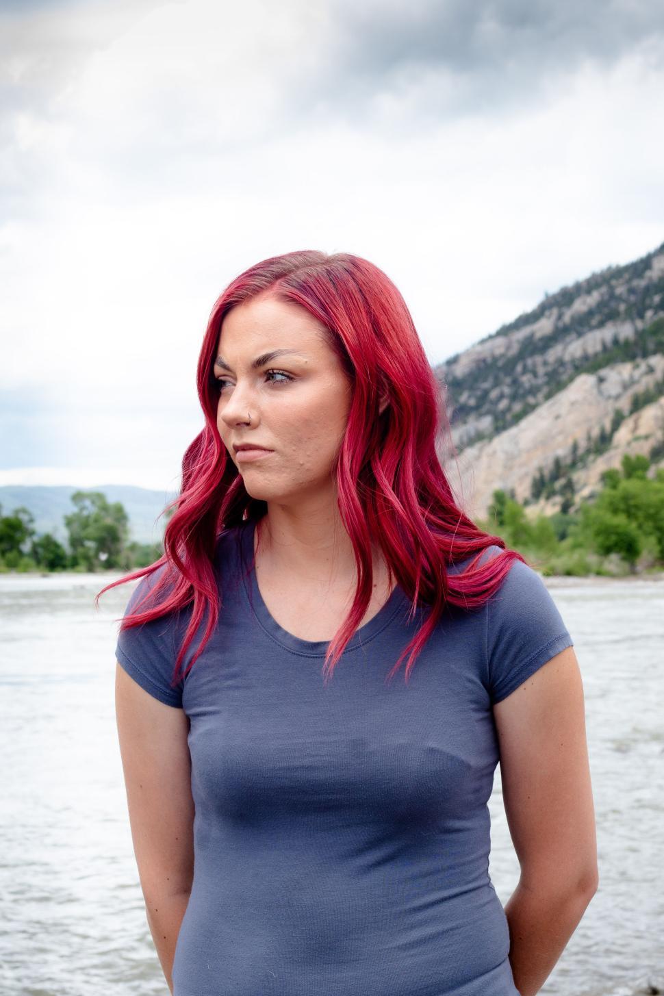 Free Image of Person with vibrant pink hair in nature setting outdoors 