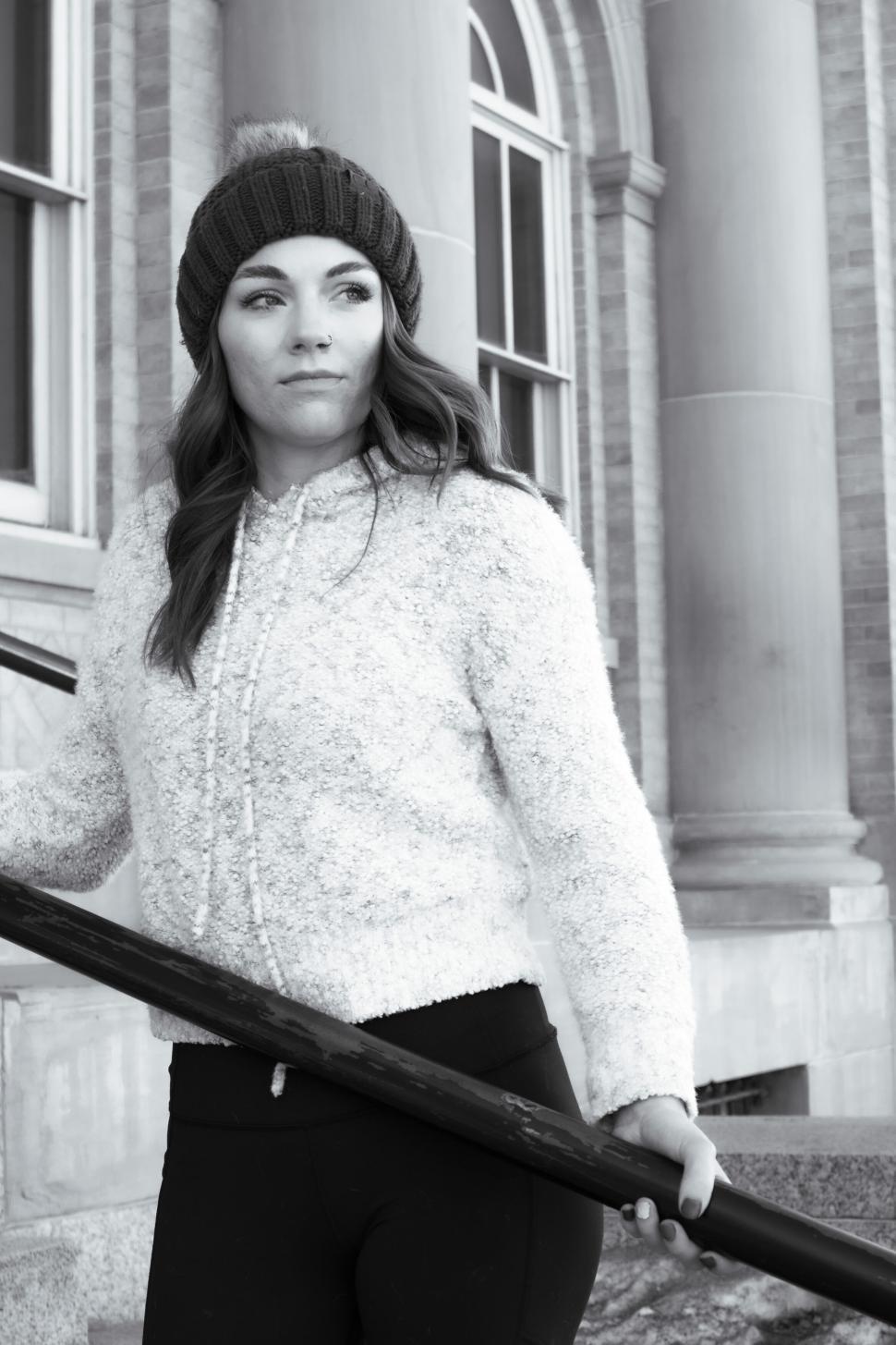 Free Image of Person in winter attire standing by stair railing. 
