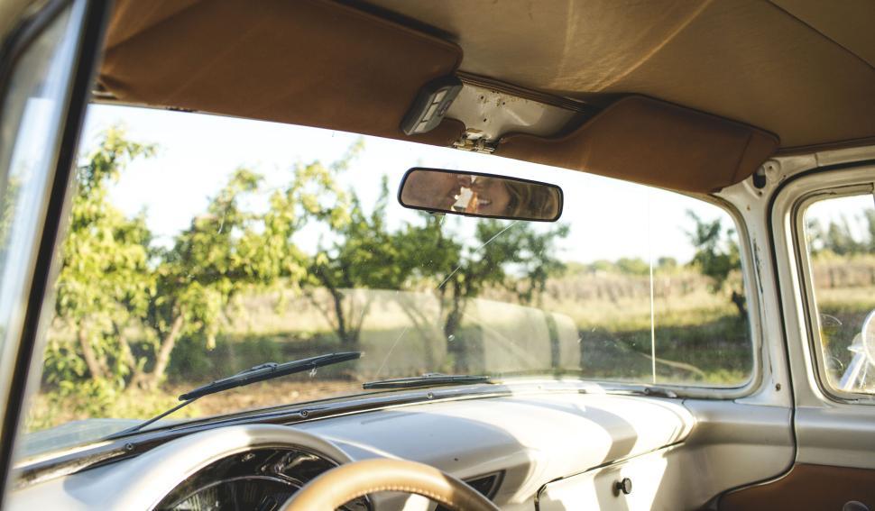 Free Image of Vintage car interior with view of the countryside. 