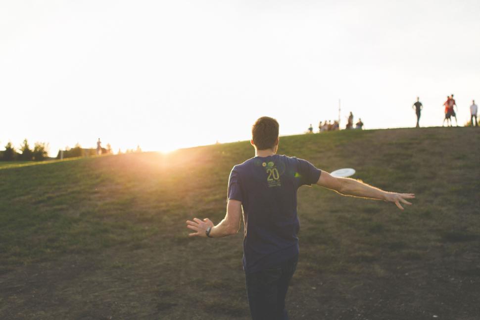 Free Image of Person playing frisbee at park during golden sunset 