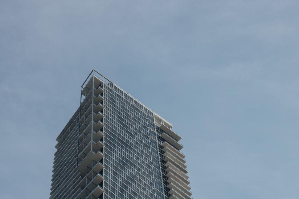 Free Image of Modern high-rise building against a clear blue sky. 