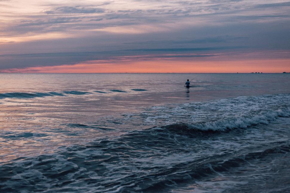 Free Image of Person kayaking at dawn on tranquil ocean waters horizon 