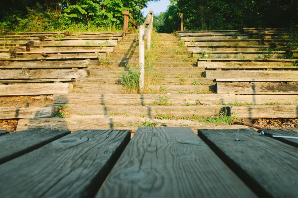 Free Image of Old wooden outdoor amphitheater with overgrown grass shrubs 