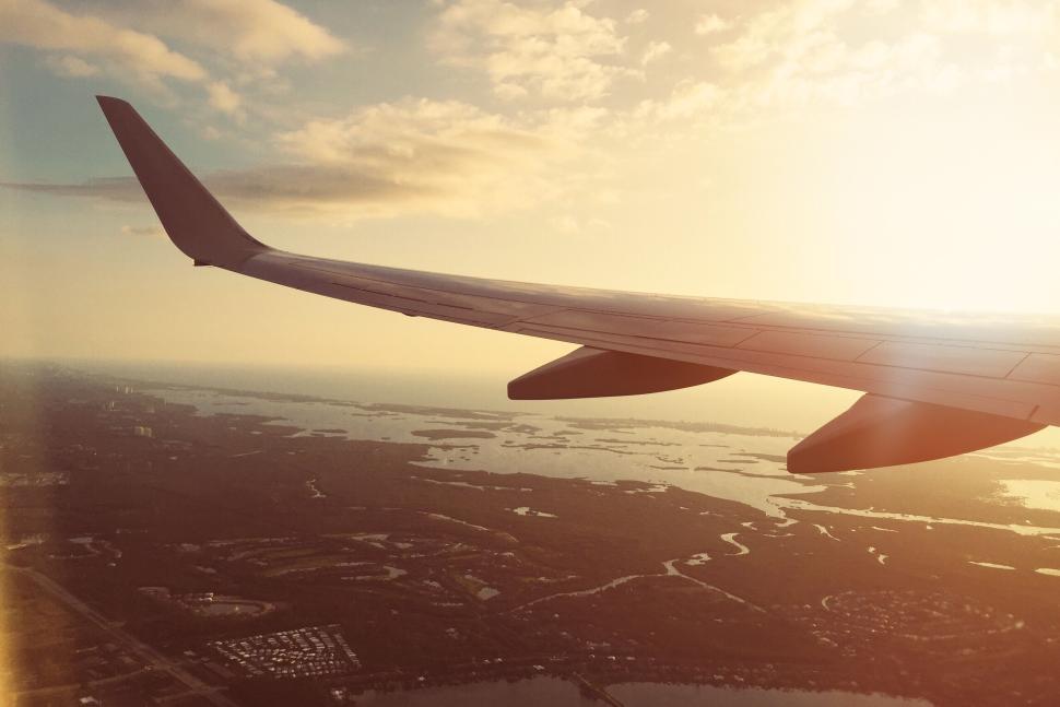 Free Image of View from airplane window flying over tranquil waters. 