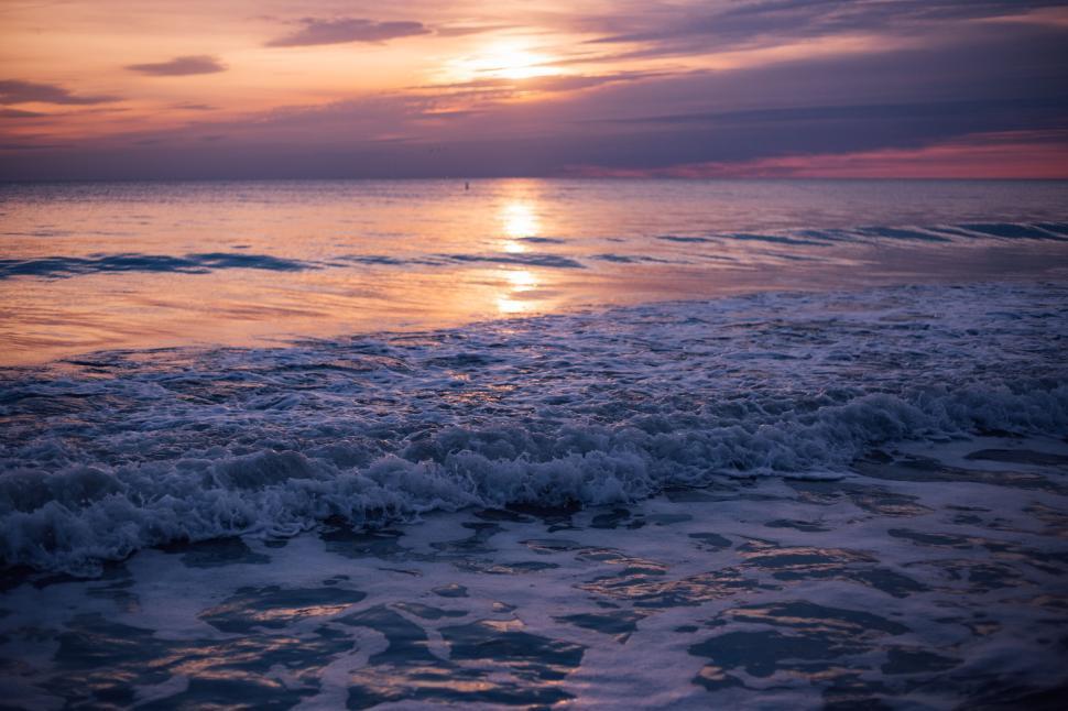 Free Image of Gentle waves under sunset light, magical and serene scene 