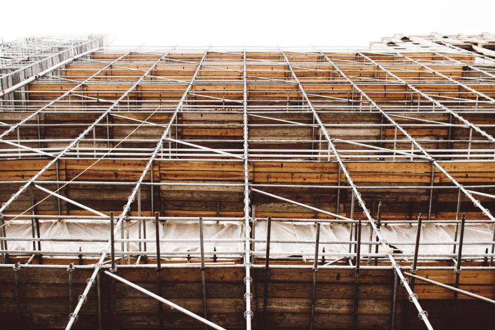 Free Image of Scaffolding setup in front of a tall building under construction 