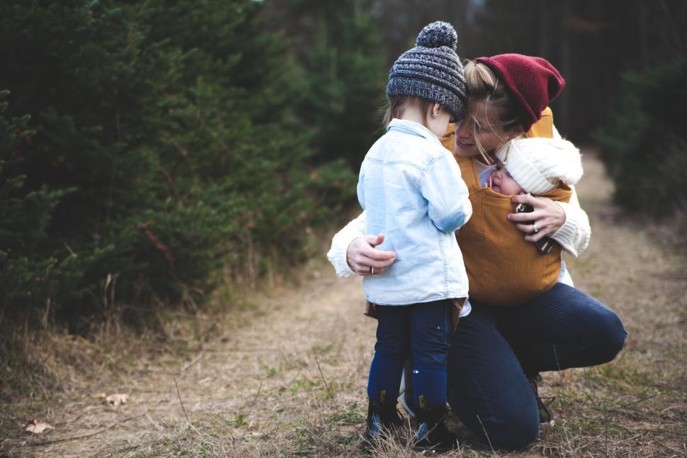 Free Image of Mom with two children in a forested path in autumn. 