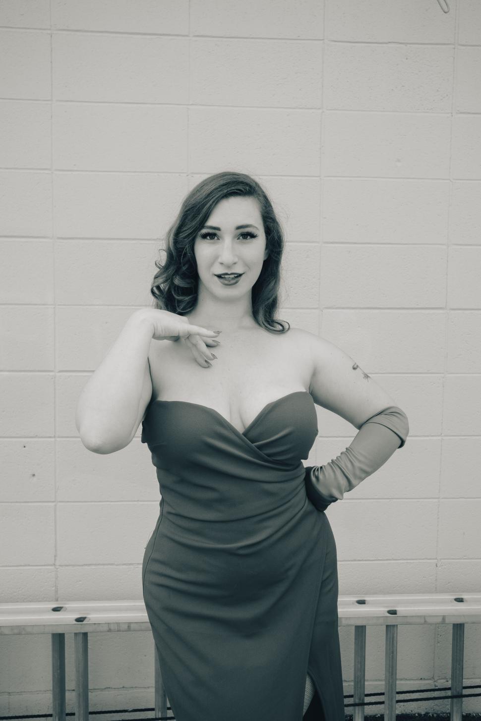 Free Image of Woman in strapless dress posing confidently 