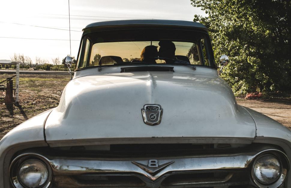 Free Image of Two people sharing a moment inside a vintage truck. 